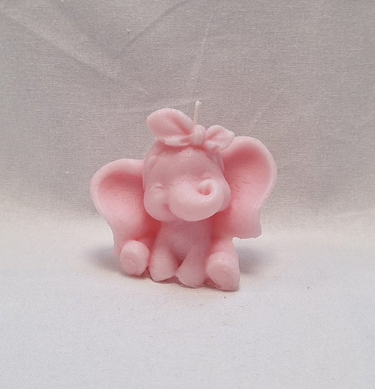 Handmade pink elephant-shaped soy wax candle with bow, perfect for baby showers or nursery décor.