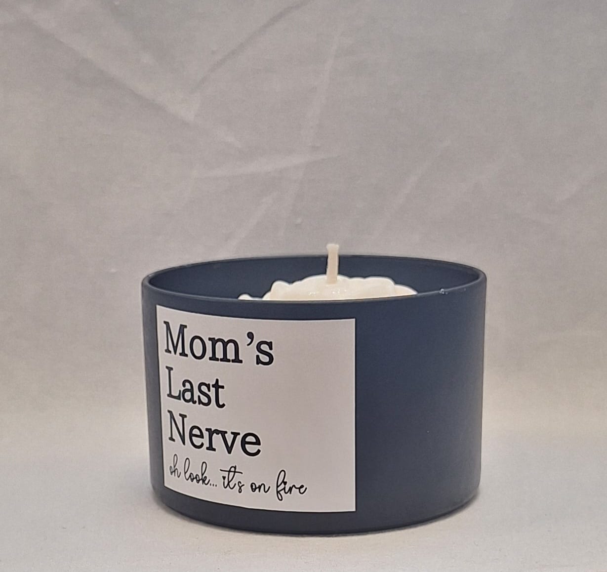 Mom’s Last Nerve scented candle in a stylish tin container with a playful label, perfect stress relief gift for moms.