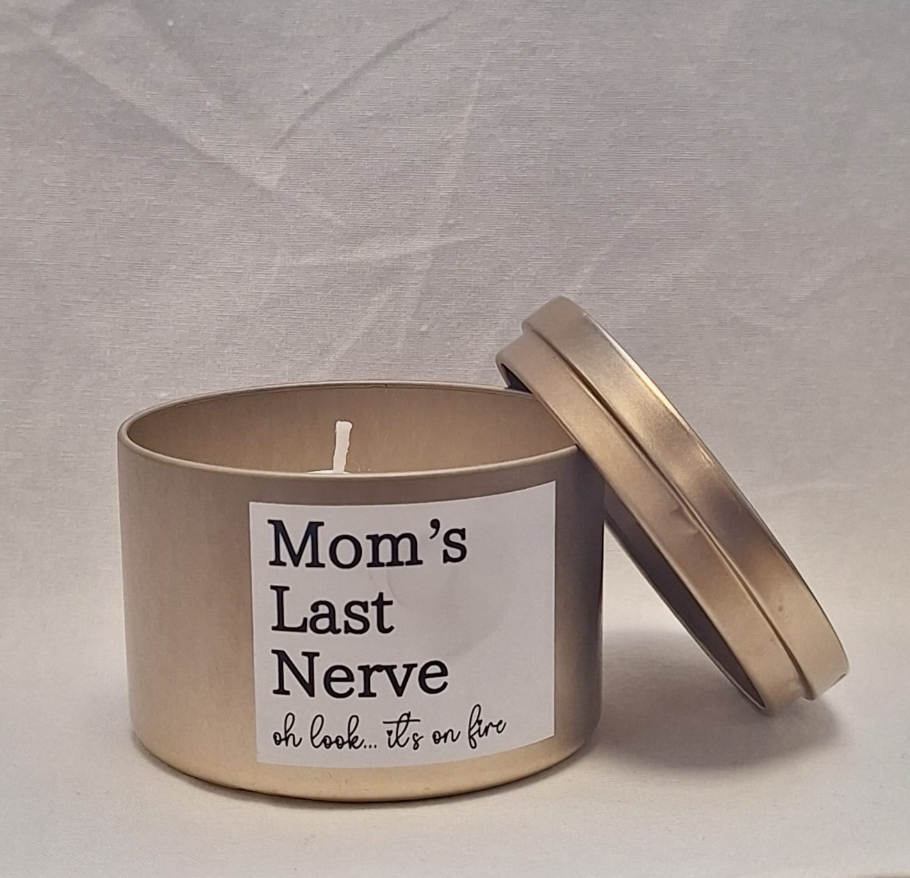 Mom’s Last Nerve scented candle in a stylish tin container with a playful label, perfect stress relief gift for moms.