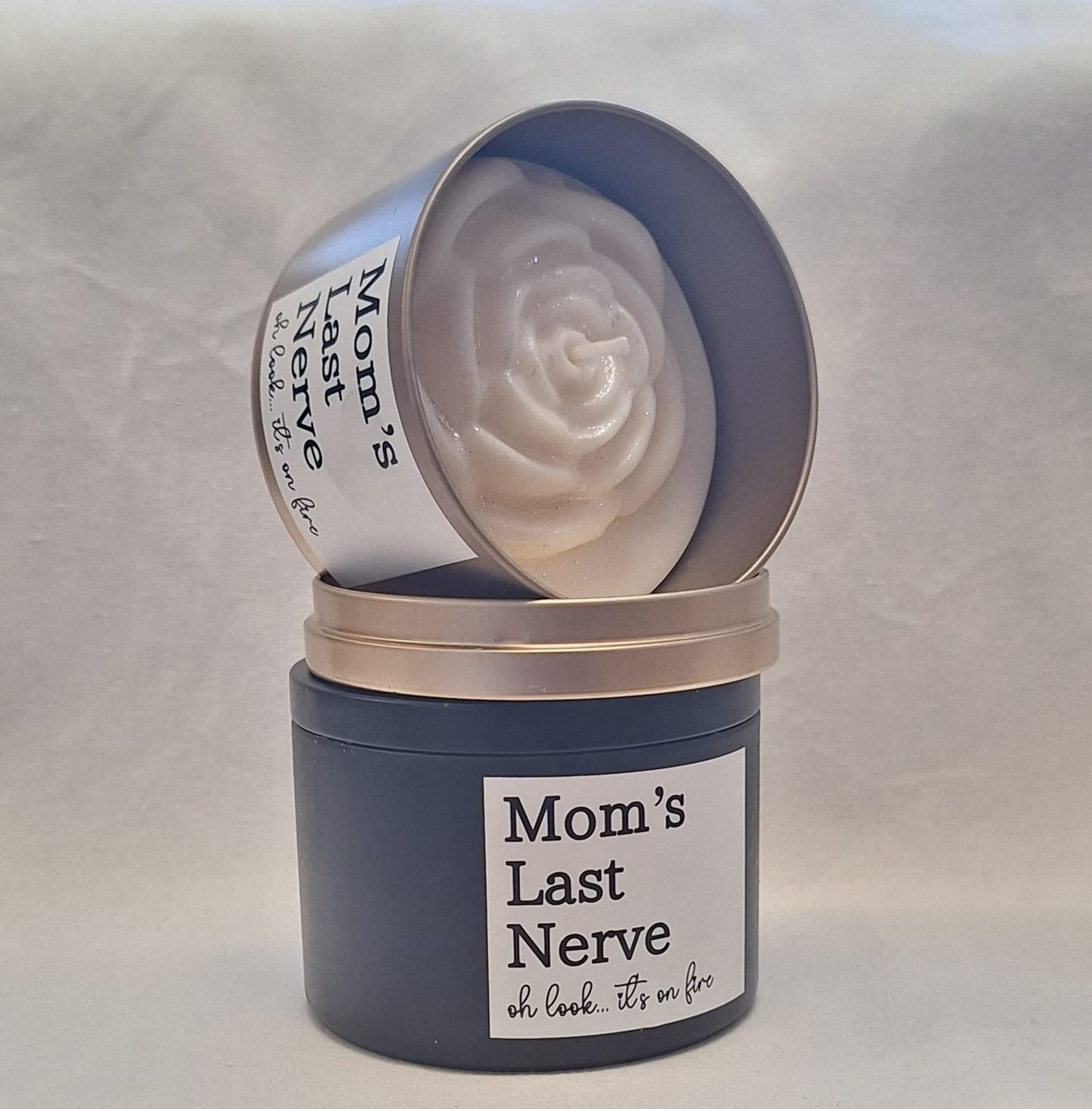 Mom’s Last Nerve scented candle in a stylish tin container with a playful label, perfect stress relief gift for moms.